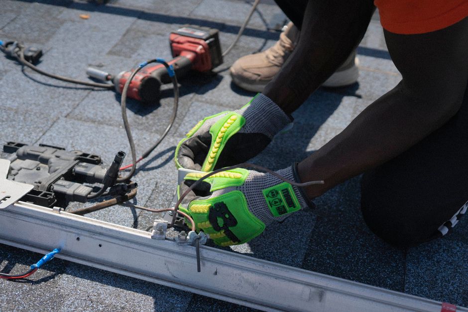 technician soft washing residential roof shingles